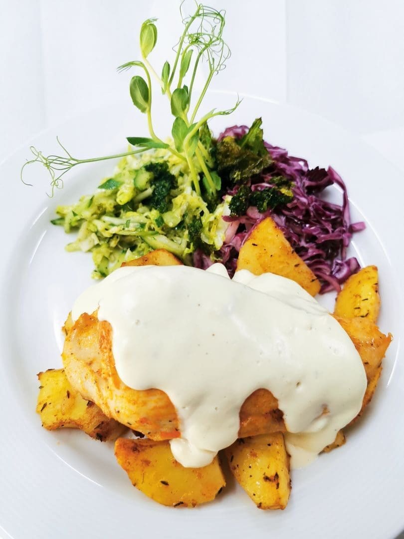 Delicious chicken breast with creamy sauce and vegetables, perfect for gourmet dining.