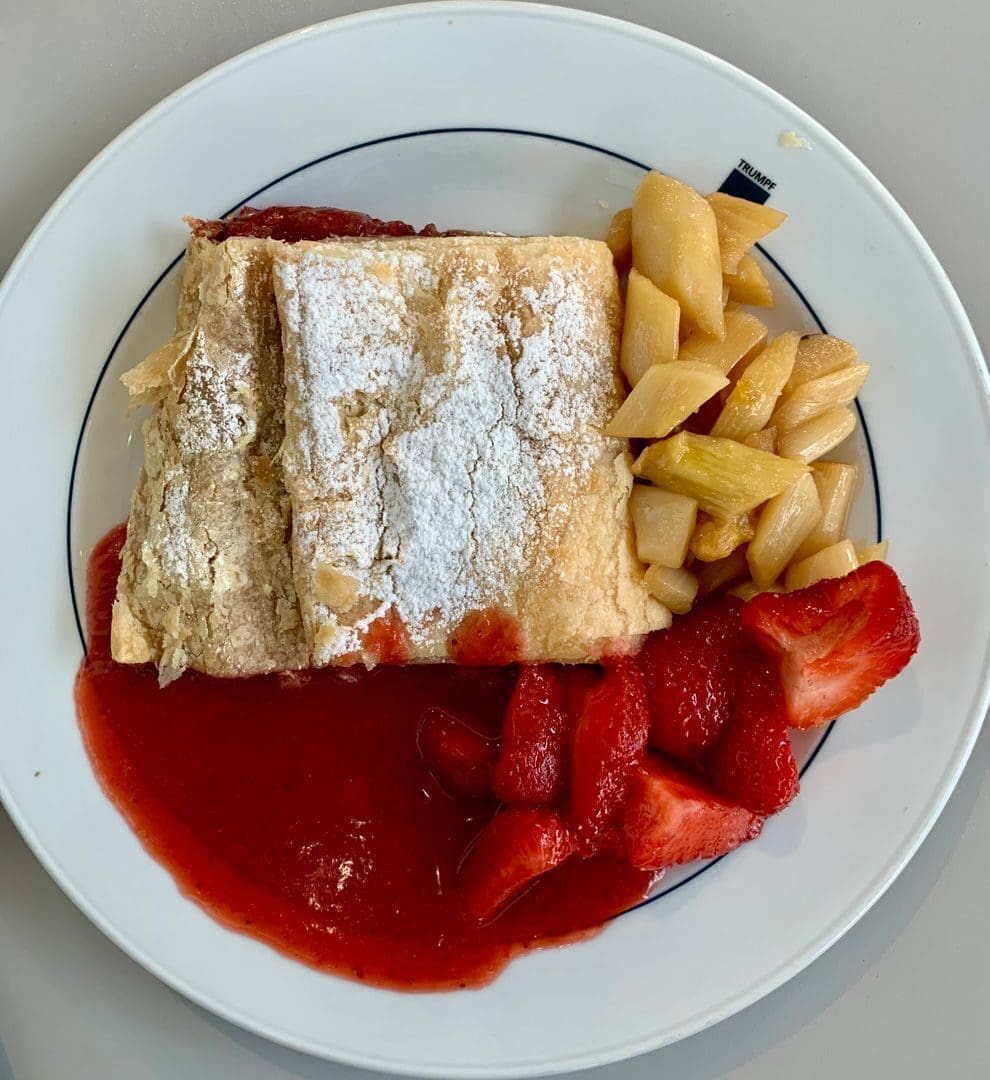 Tasty pastry served with strawberries and fruit compote in Pasching, Austria.